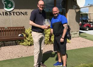 Andrew receiving his trophy from Club Captain Stuart Milne.